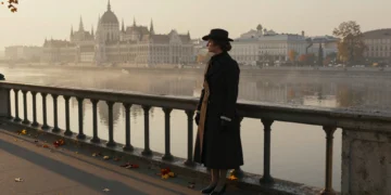 Mujer elegante del siglo XIX contempla el Danubio desde el Puente de las Cadenas de Budapest al amanecer