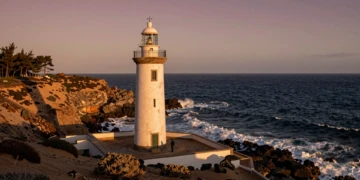 Faro andaluz sobre acantilado al atardecer con el océano Atlántico al fondo, desde Huelva hasta Almería